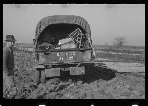 Untitled photo, possibly related to: Unloading the household goods of a family who is being moved into the camp for white flood refugees at Forrest City, Arkansas