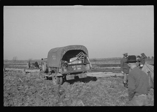 Untitled photo, possibly related to: Unloading the household goods of a family who is being moved into the camp for white flood refugees at Forrest City, Arkansas