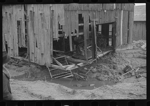 Barn and farm equipment ruined by flood waters. Hatfield, Massachusetts