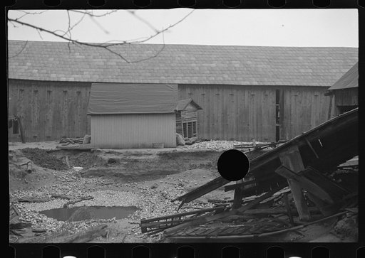 Untitled photo, possibly related to: Barn and farm equipment ruined by flood waters. Hatfield, Massachusetts