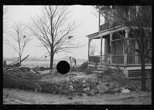 Untitled photo, possibly related to: Flood debris in yard of resettlement client. The wheelbarrow floated to its precarious position on the roof. Hatfield, Massachusetts
