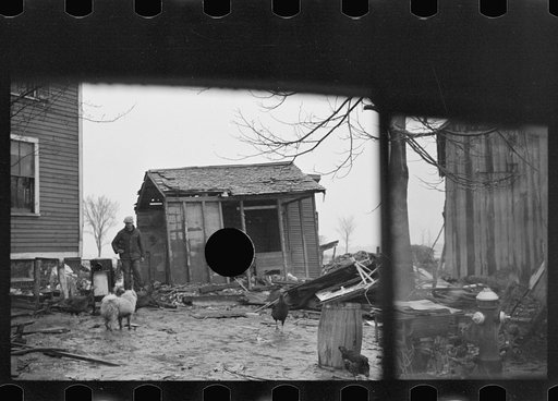 Untitled photo, possibly related to: Flood debris in yard of resettlement client. The wheelbarrow floated to its precarious position on the roof. Hatfield, Massachusetts