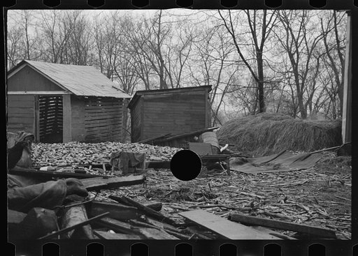 Untitled photo, possibly related to: Flood debris in yard of resettlement client. The wheelbarrow floated to its precarious position on the roof. Hatfield, Massachusetts