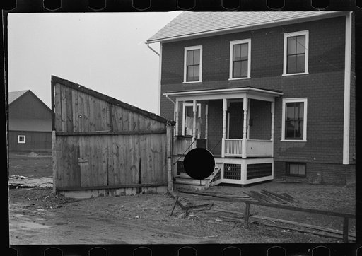 Untitled photo, possibly related to: Flood debris in yard of resettlement client. The wheelbarrow floated to its precarious position on the roof. Hatfield, Massachusetts