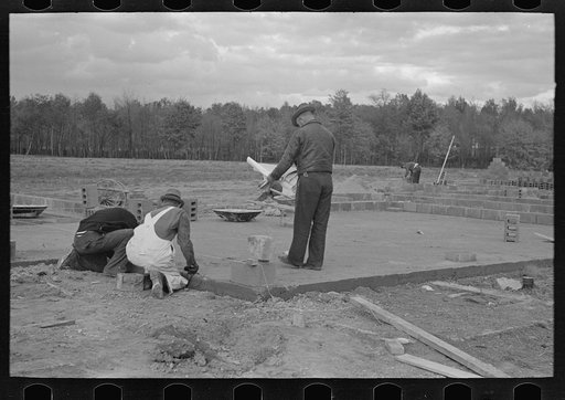 Untitled photo, possibly related to: Construction of houses (reading plans and measuring), Jersey Homesteads, Hightstown, New Jersey
