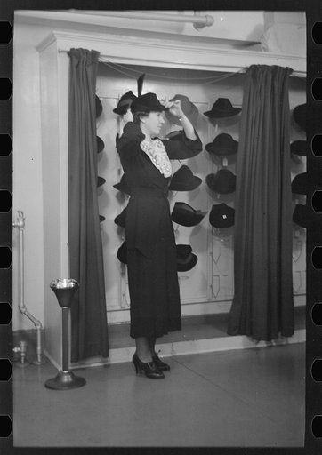Model trying on hat for a buyer, New York City showroom, Jersey Homesteads cooperative