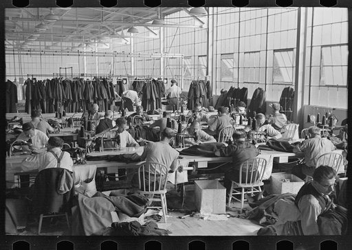 Interior of cooperative garment factory at Jersey Homesteads, showing some of the eighty homesteaders at their work and some of the ladies' coats made by them. Hightstown, New Jersey