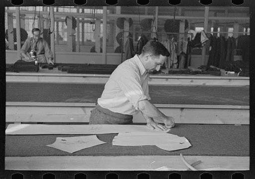 Louis Gushen, chief cutter in the cooperative garment factory at Jersey Homesteads, marks out the pattern of a woman's coat, which will be made in the factory, Hightstown, New Jersey