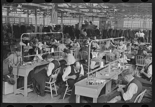 Interior of cooperative garment factory at Jersey Homesteads, showing some of eighty homesteaders at their work and some of the ladies' coats made by them. Hightstown, New Jersey