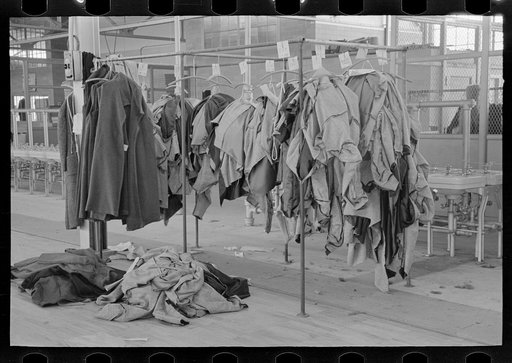 Half-made garments on the racks, awaiting final operations of the machines, in cooperative garment factory, Hightstown, New Jersey