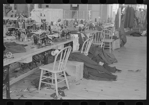 Untitled photo, possibly related to: Half-made garments on the racks, awaiting final operations of the machines, in cooperative garment factory, Hightstown, New Jersey