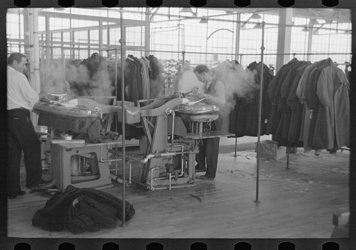Steam pressing the cloth is one process in manufacturing women's coats at Jersey Homesteads, Hightstown