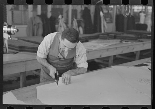 Louis Gushen, chief cutter in the cooperative garment factory of Jersey Homesteads, is cutting the pattern for a woman's coat. Hightstown, New Jersey