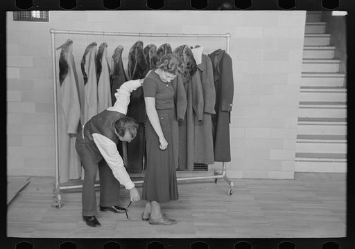 Untitled photo, possibly related to: Measuring girl for a coat in cooperative garment factory at Jersey Homesteads, Hightstown, New Jersey