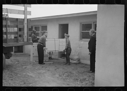 Abe Lipsky, farm foreman (left), has moved into his new home after living in temporary quarters at Jersey Homesteads for more than a year. He is being helped in the moving by Harry Katzenellenbogen, another farmer