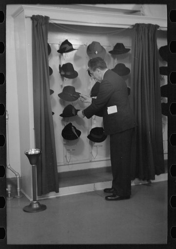 Untitled photo, possibly related to: Model trying on hat for a buyer, New York City showroom, Jersey Homesteads cooperative
