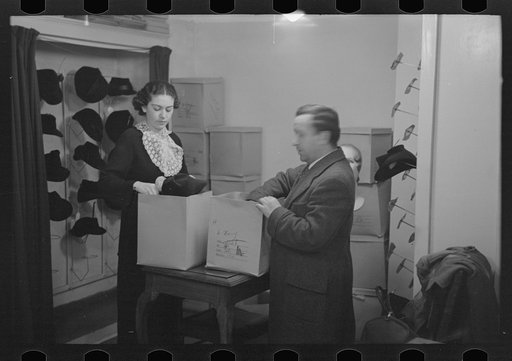 Untitled photo, possibly related to: Model trying on hat for a buyer, New York City showroom, Jersey Homesteads cooperative