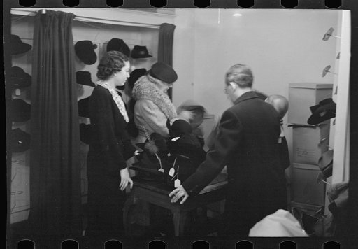 Untitled photo, possibly related to: Model trying on hat for a buyer, New York City showroom, Jersey Homesteads cooperative