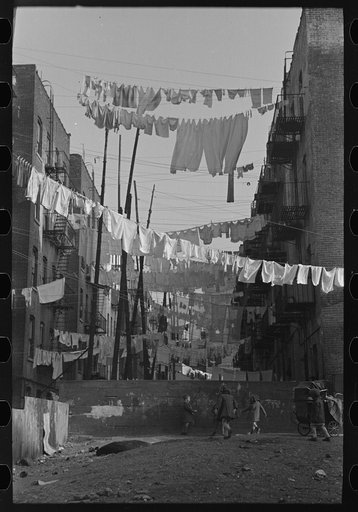 An avenue of clothes washings between 138th and 139th Street apartments, just east of St. Anne's Avenue, Bronx, New York