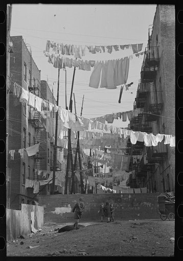 Untitled photo, possibly related to: An avenue of clothes washings between 138th and 139th Street apartments, just east of St. Anne's Avenue, Bronx, New York