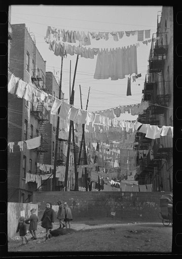 Untitled photo, possibly related to: An avenue of clothes washings between 138th and 139th Street apartments, just east of St. Anne's Avenue, Bronx, New York