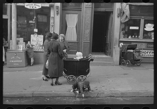 Mothers talking together and child playing in the gutter, 139th Street just east of St. Anne's Avenue, Bronx, New York