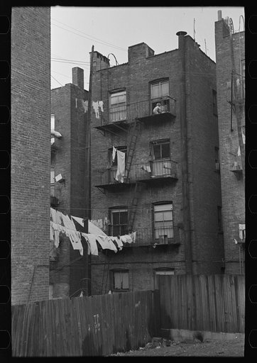 Apartment houses as viewed through vacant lot. In the vicinity of 139th street just east of St. Anne's Avenue, Bronx, New York