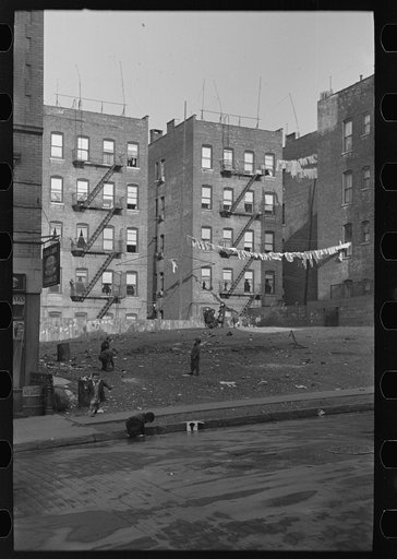 Apartment houses as viewed through vacant lot. In vicinity of 139th Street just east of St. Anne's Avenue Bronx, New York