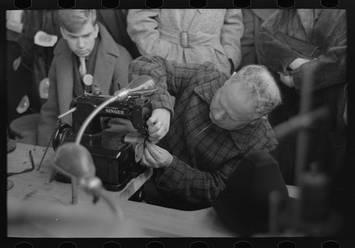 Man working at special sewing machine for hats, Jersey Homesteads, New Jersey