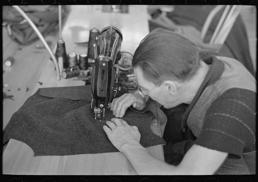 Untitled photo, possibly related to: Closeup of man working sewing machine in garment factory, Jersey Homesteads, Hightstown, New Jersey