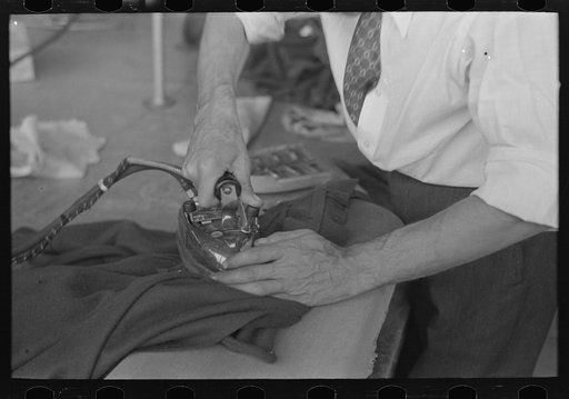 Closeup of presser's hands, Jersey Homesteads factory, Hightstown, New Jersey
