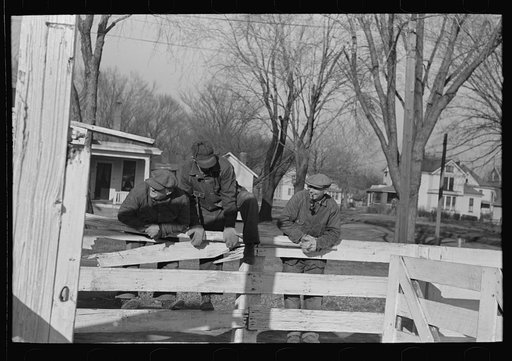 Untitled photo, possibly related to: Stockyard attendants herding hogs into pens at stockyards, Aledo, Illinois