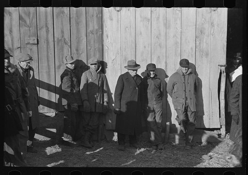 Untitled photo, possibly related to: Farmers in shed at country auction near Aledo, Mercer County, Illinois
