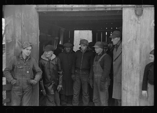 Farmers in shed at country auction near Aledo, Mercer County, Illinois