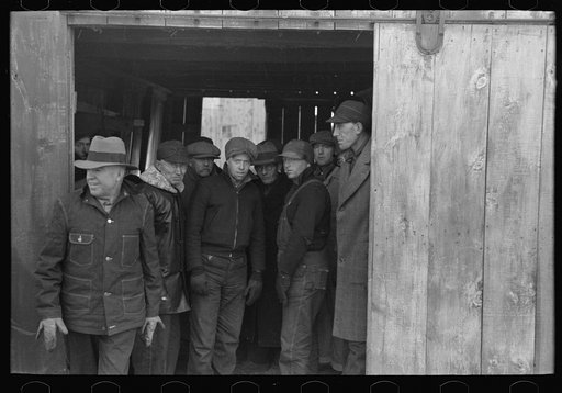 Untitled photo, possibly related to: Farmers in shed at country auction near Aledo, Mercer County, Illinois