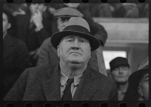 Closeup of farmer, spectator livestock sales hall, Ames, Iowa