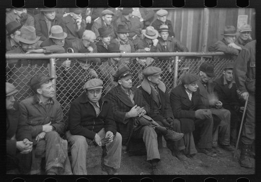 Farmers sitting inside sales ring of livestock sales hall Ames, Iowa