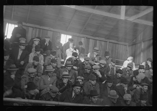 Untitled photo, possibly related to: Farmers sitting inside sales ring of livestock sales hall Ames, Iowa