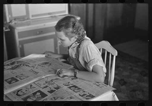 Rustan's daughter reading a Sunday paper. Rustan brothers' farm near Dickens, Iowa
