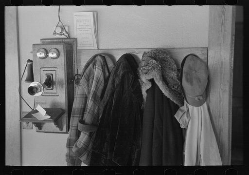 Garments hanging near telephone in Rustan brothers' farm near Dickens, Iowa