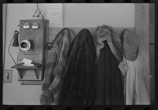 Untitled photo, possibly related to: Garments hanging near telephone in Rustan brothers' farm near Dickens, Iowa
