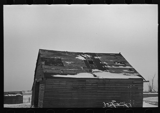 Corn crib on Joe Beving's farm near Dickens, Iowa. Note condition of roof