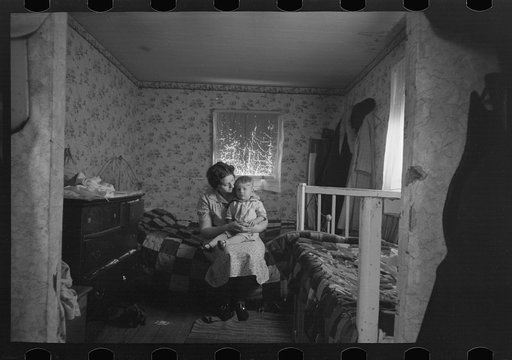 Mother and child in another bedroom of the Nissen shack near Dickens, Iowa
