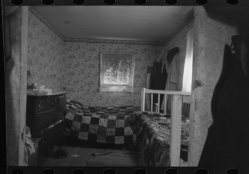 Untitled photo, possibly related to: Mother and child in crowded bedroom of home of L.H. Nissen, hired man. He is married, has seven children, one grandchild, all living together in three rooms