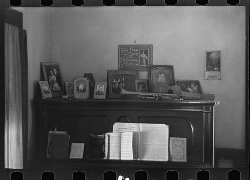 Piano with photograph and mementos in the farmhouse of J E. Herbrandson near Estherville, Iowa