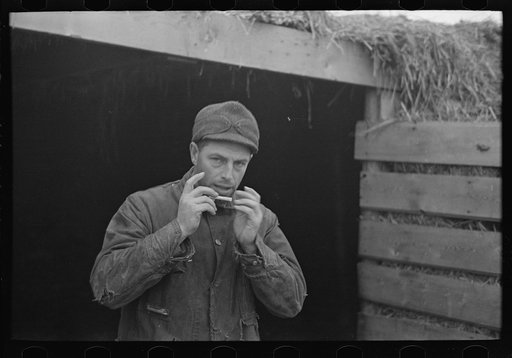 Rex Inman, farmer, near Estherville, Iowa, rolling a cigarette. Very few farmers smoke "tailor mades"