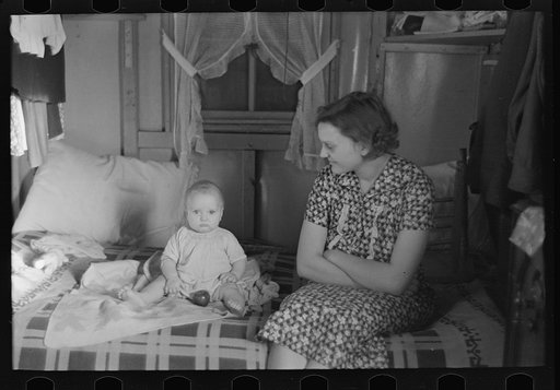 Mrs. Charles Benning and baby in their shack home at Shantytown, Spencer, Iowa