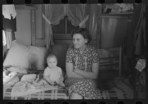 Untitled photo, possibly related to: Mrs. Charles Benning and baby in their shack home at Shantytown, Spencer, Iowa
