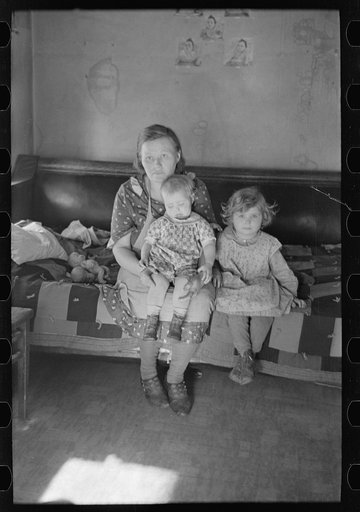 Untitled photo, possibly related to: Mrs. Paul Rauhauser and two of her seven children in their home at Ruthven, Iowa