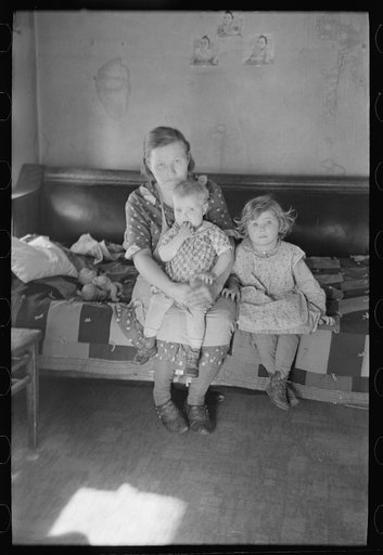Untitled photo, possibly related to: Mrs. Paul Rauhauser and two of her seven children in their home at Ruthven, Iowa